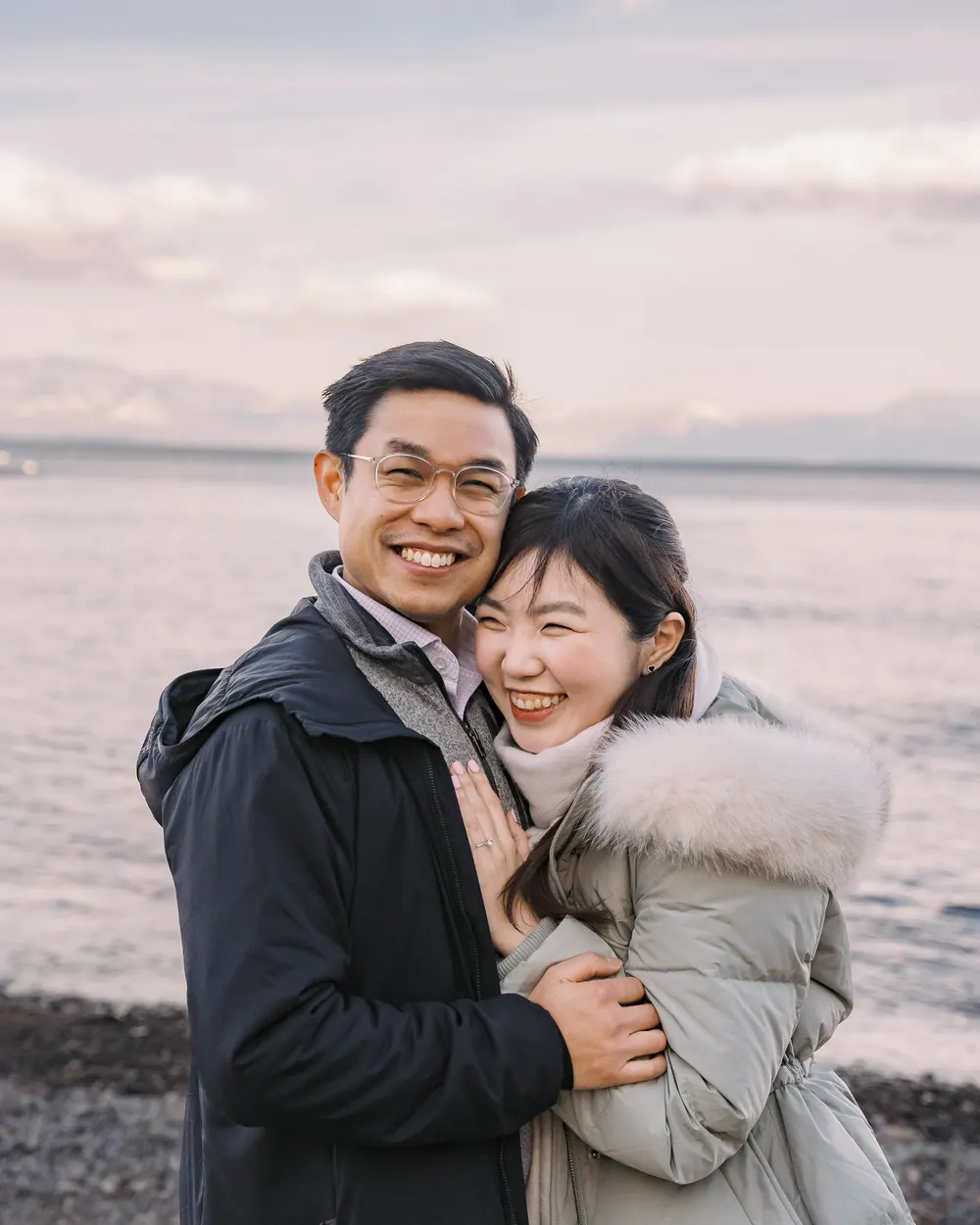 Jingwen and Thai wrapped up against the cold, holding each other on the shore of Lake Tahoe
